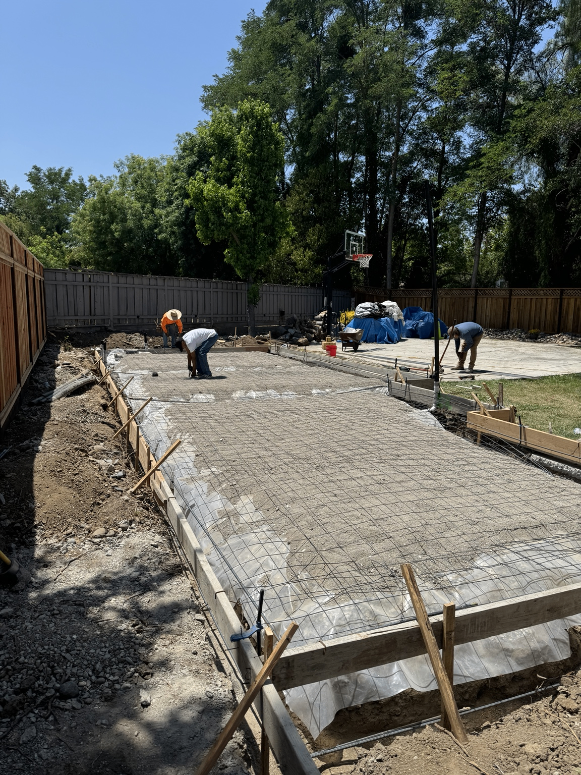Concrete foundation preparation with formwork and rebar grid.