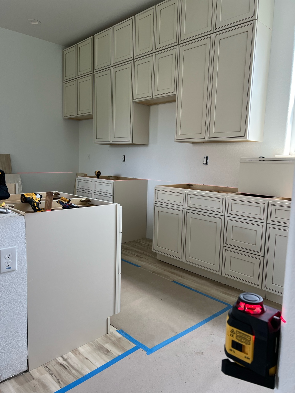 Cabinet installation underway in a bright kitchen remodel.